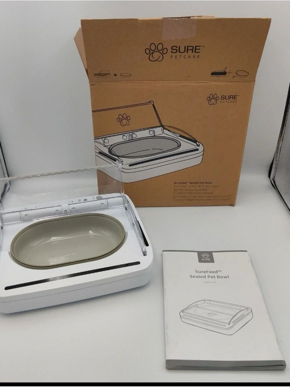 New in box. SureFeed Sealed Pet Bowl – White Base with Beige Removable Bowl